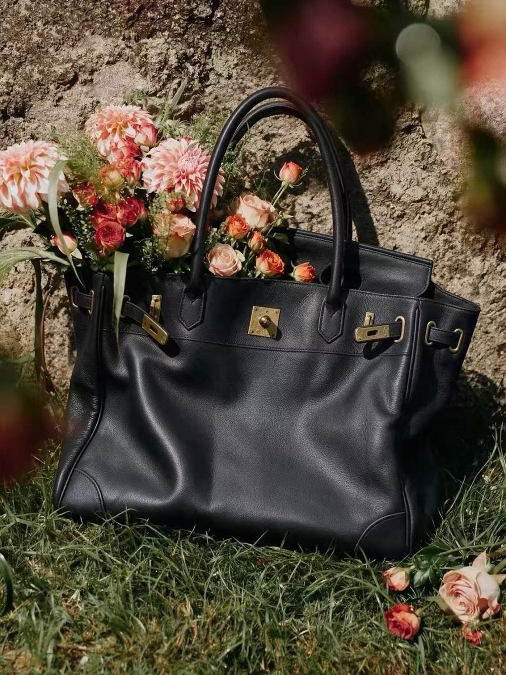 Black Folded-Flap Handbag with Gold-Tone Hardware — hero