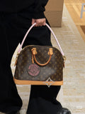 Louis Vuitton Alma Monogram Handbag with Pink Strap — model