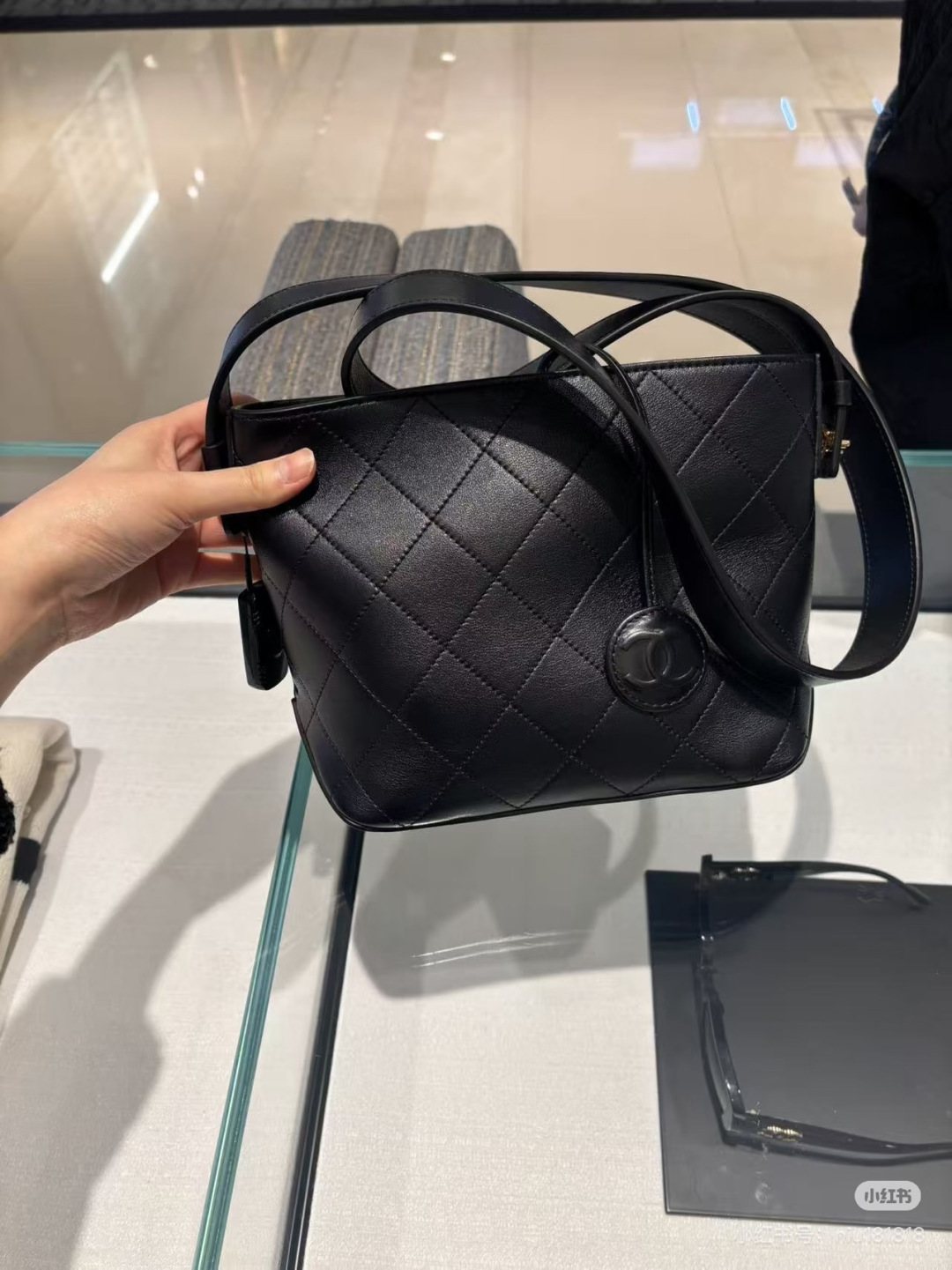 Chanel Diamond-Quilted Pendant Bucket Bag — model