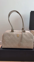 Chanel Diamond-Quilted Bowling Bag with Round Charm — hero