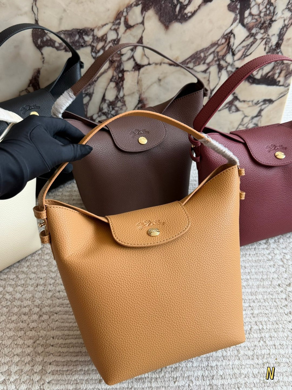 Longchamp Pebbled Bucket Bag with Rounded Snap Flap — front