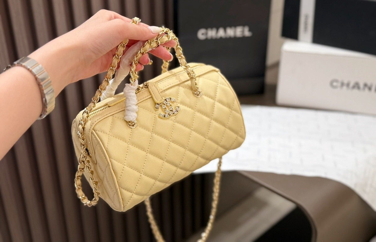 Chanel Quilted Bowling Bag with Jeweled CC Emblem — model