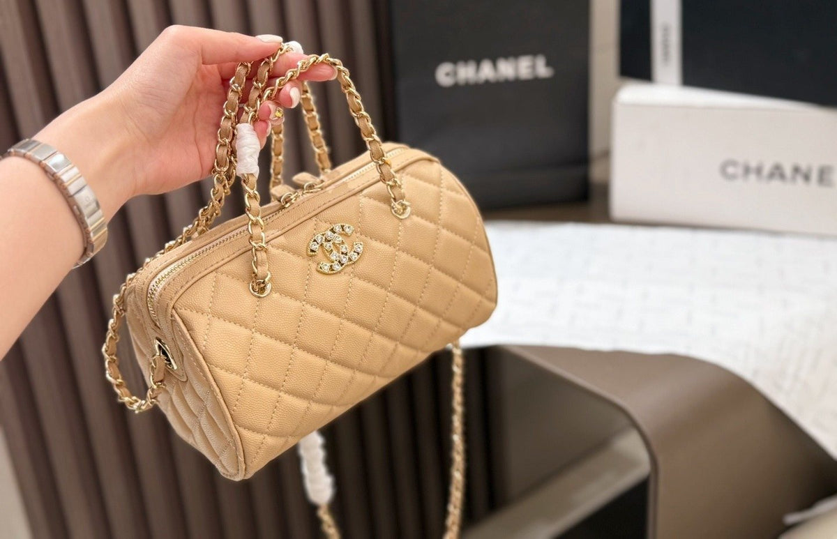 Chanel Quilted Bowling Bag with Jeweled CC Emblem — model